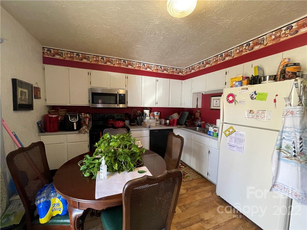 7400 R R H Road Hickory, NC 28602 - Photo 10 of 30 a kitchen with furniture a refrigerator and a dining table