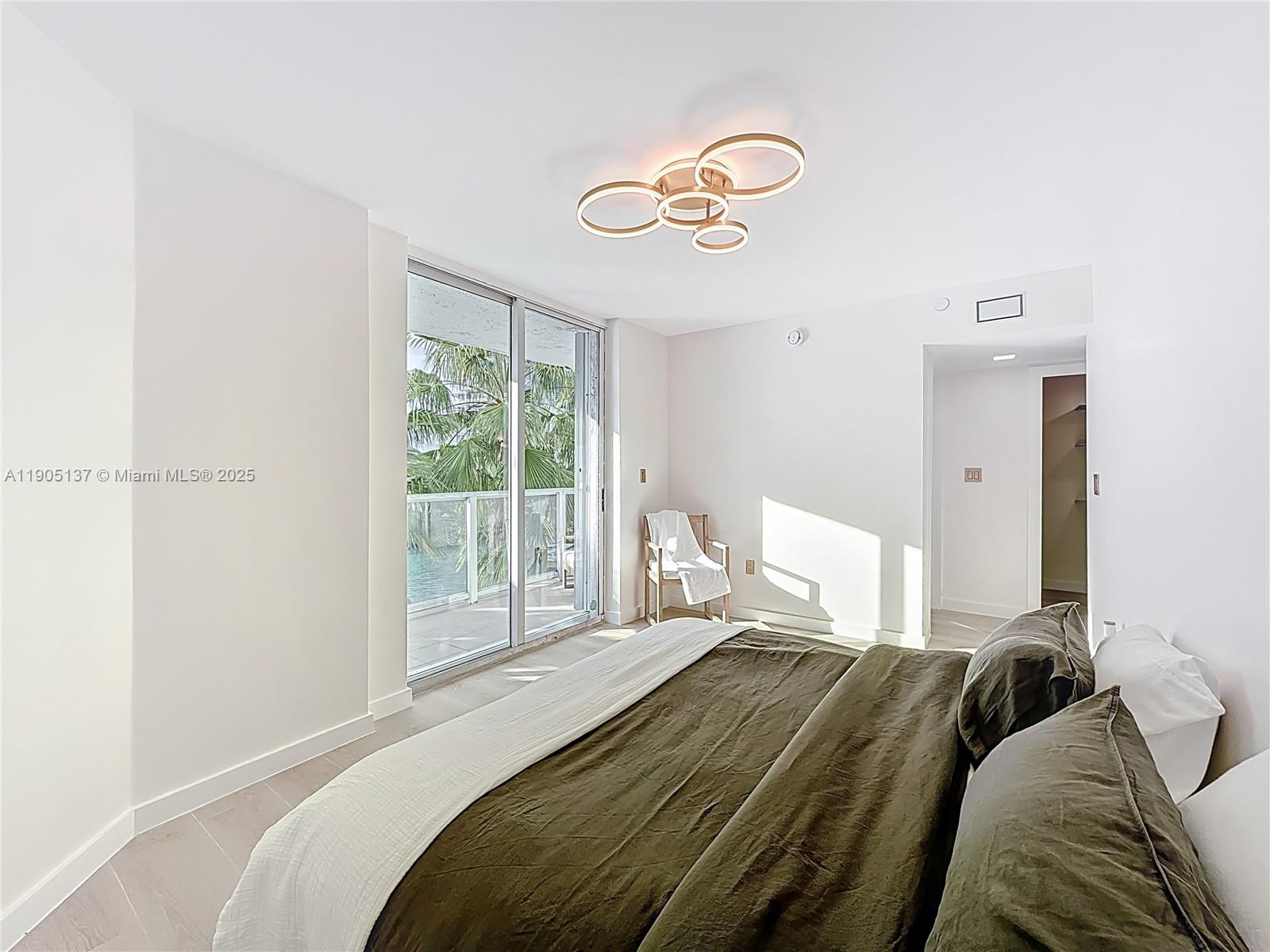 5900 Collins Avenue, Unit 508 Miami Beach, FL 33140 - Photo 18 of 39 a bedroom with a bed and a large window