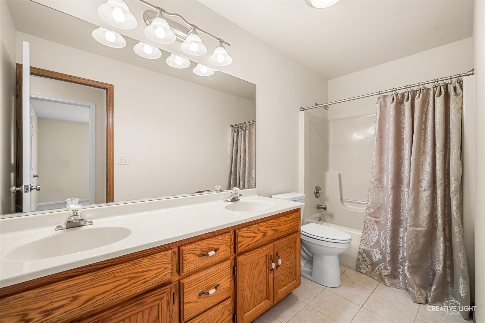 714 East Knights Road Sandwich, IL 60548 - Photo 16 of 33 a bathroom with double vanity sink a toilet a mirror and vanity