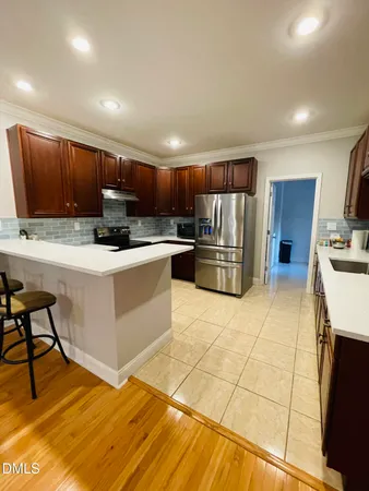 a kitchen with stainless steel appliances granite countertop a sink and cabinets