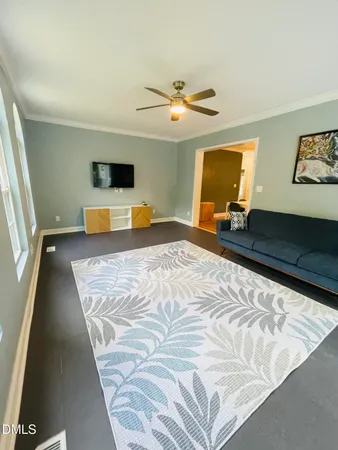 a living room with dining room and kitchen view