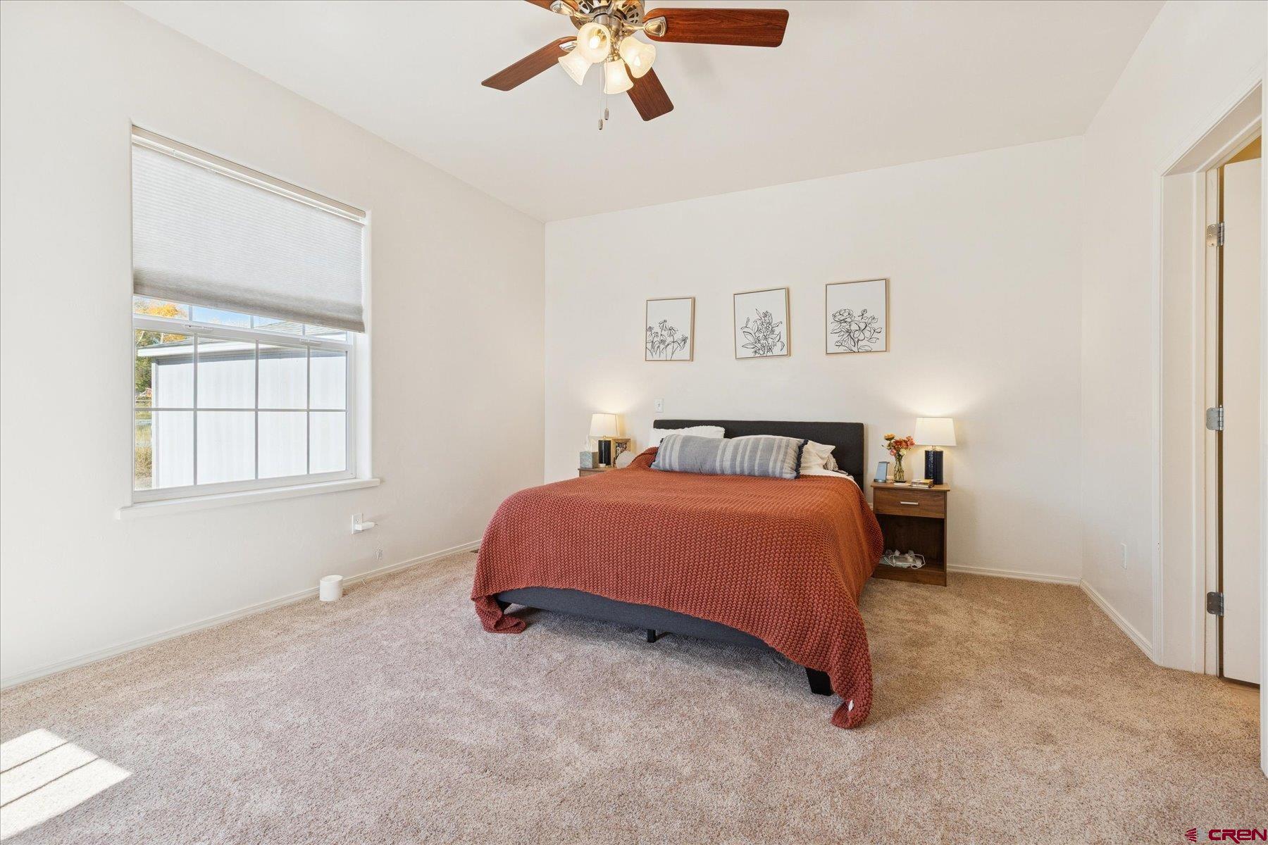 721 Arbor Street Cortez, CO 81321 - Photo 5 of 16 a spacious bedroom with a bed and a window