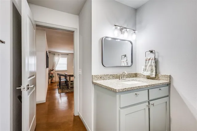 a bathroom with a sink vanity and a mirror