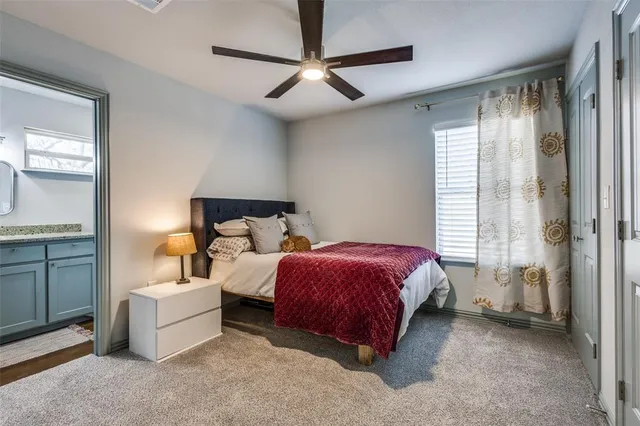 a spacious bedroom with a bed and a chandelier