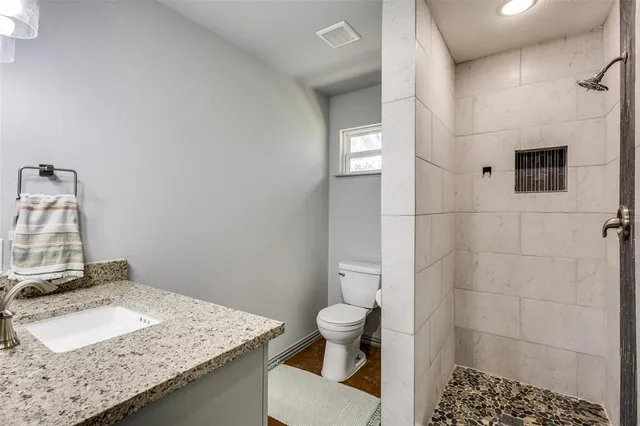 a bathroom with a sink toilet and shower