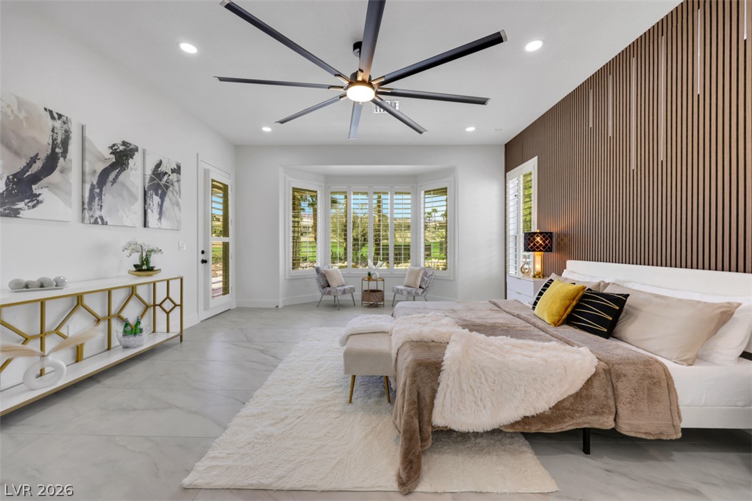 5015 Rivedro Street Las Vegas, NV 89135 - Photo 51 of 91 A spacious bedroom presents a striking bay window with scenic views and a contemporary ceiling fan.