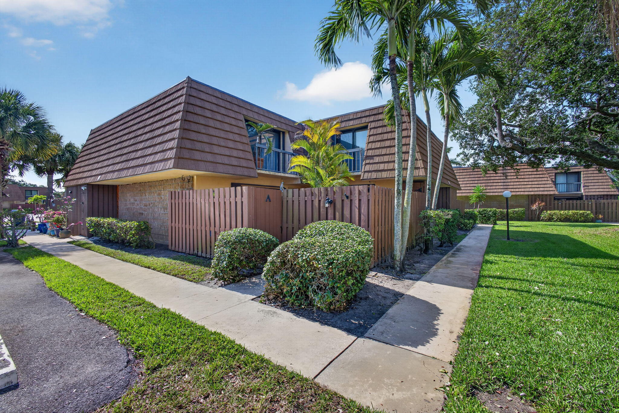 825 Center Street, Unit 50A Jupiter, FL 33458 - Photo 1 of 53 a front view of a house with garden