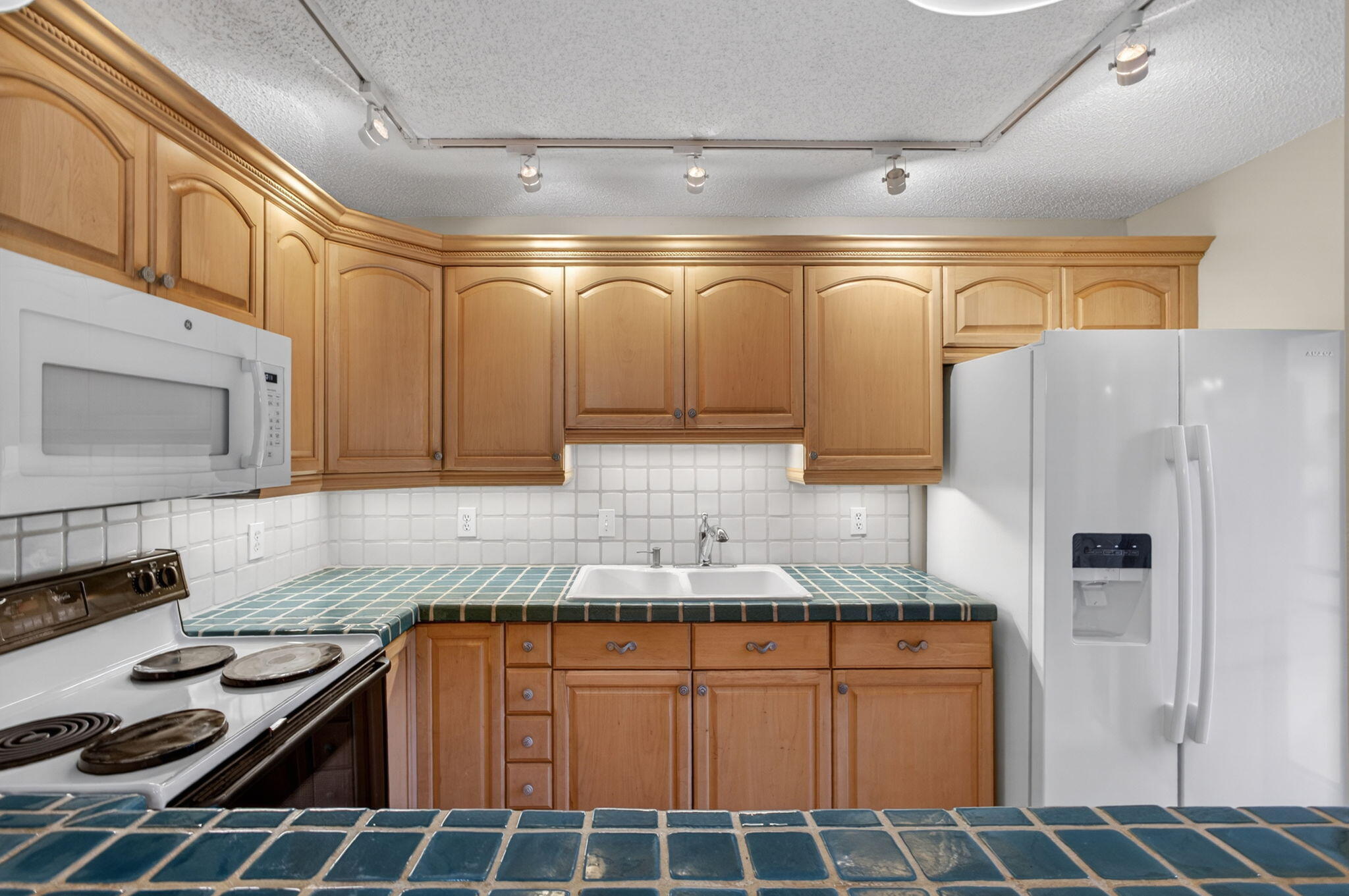 825 Center Street, Unit 50A Jupiter, FL 33458 - Photo 12 of 53 a kitchen with stainless steel appliances granite countertop a sink and a refrigerator