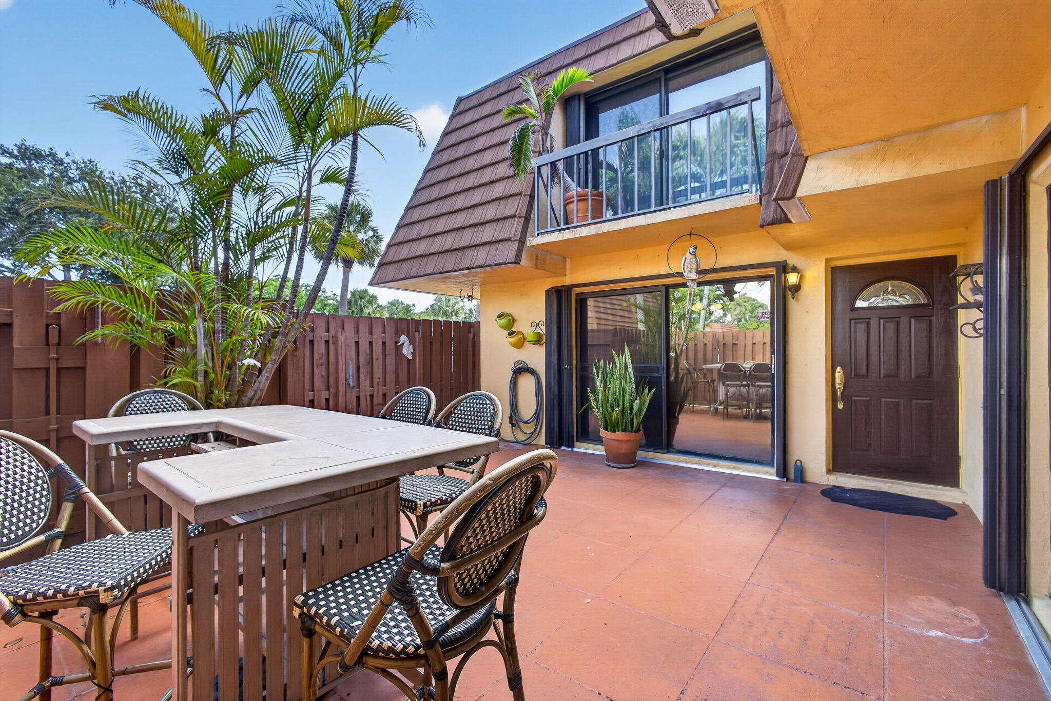 825 Center Street, Unit 50A Jupiter, FL 33458 - Photo 5 of 53 a view of a patio with table and chairs with wooden floor and fence