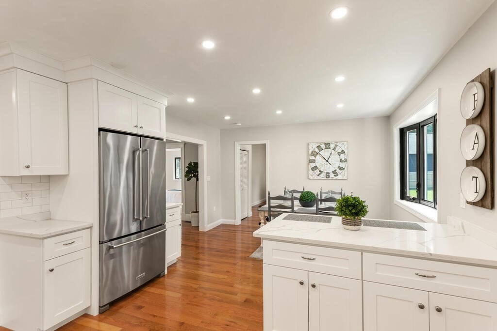 58 Maple Road Melrose, MA 02176 - Photo 11 of 34 a kitchen with stainless steel appliances a refrigerator sink and cabinets