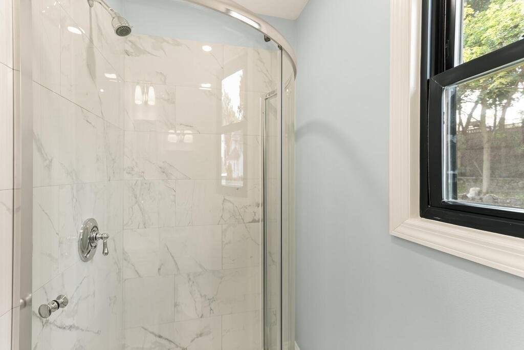 58 Maple Road Melrose, MA 02176 - Photo 19 of 34 a bathroom with a glass shower door