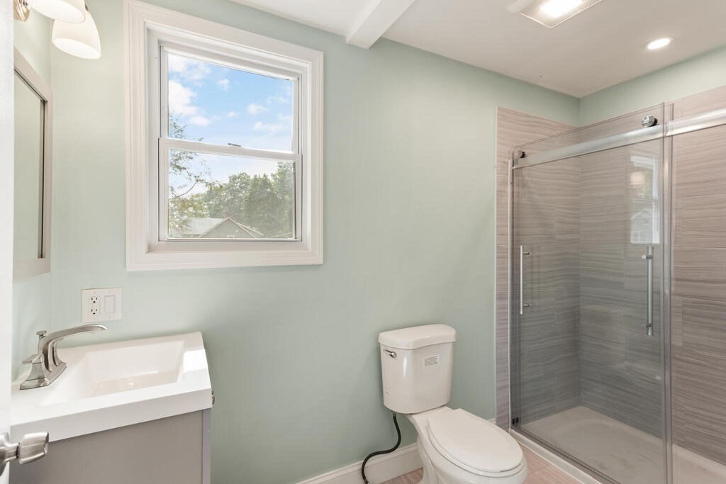 58 Maple Road Melrose, MA 02176 - Photo 23 of 34 a white toilet sitting next to a bathroom sink