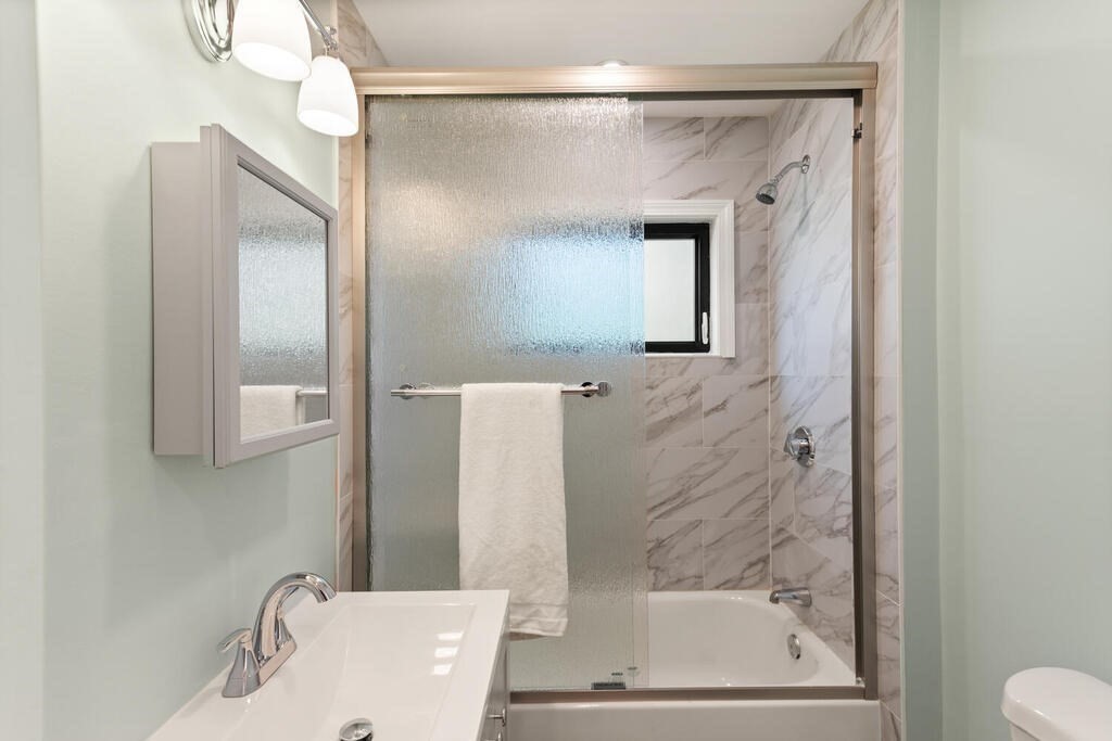 58 Maple Road Melrose, MA 02176 - Photo 25 of 34 a bathroom with a tub shower vanity and a sink