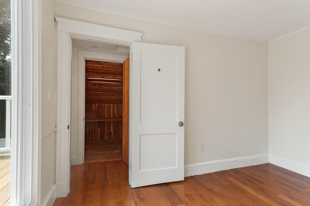 58 Maple Road Melrose, MA 02176 - Photo 27 of 34 an empty room with wooden floor closet and windows