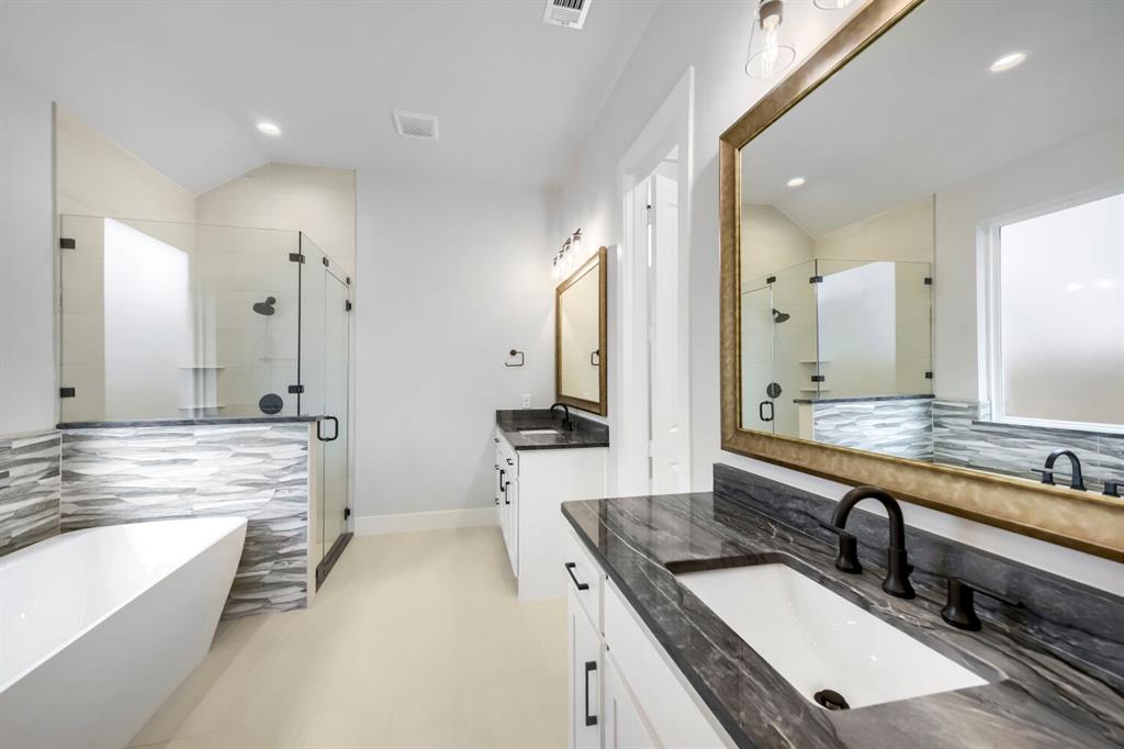 799 Mandrake Road Haslet, TX 76052 - Photo 15 of 27 a bathroom with a granite countertop sink large mirror and a bathtub