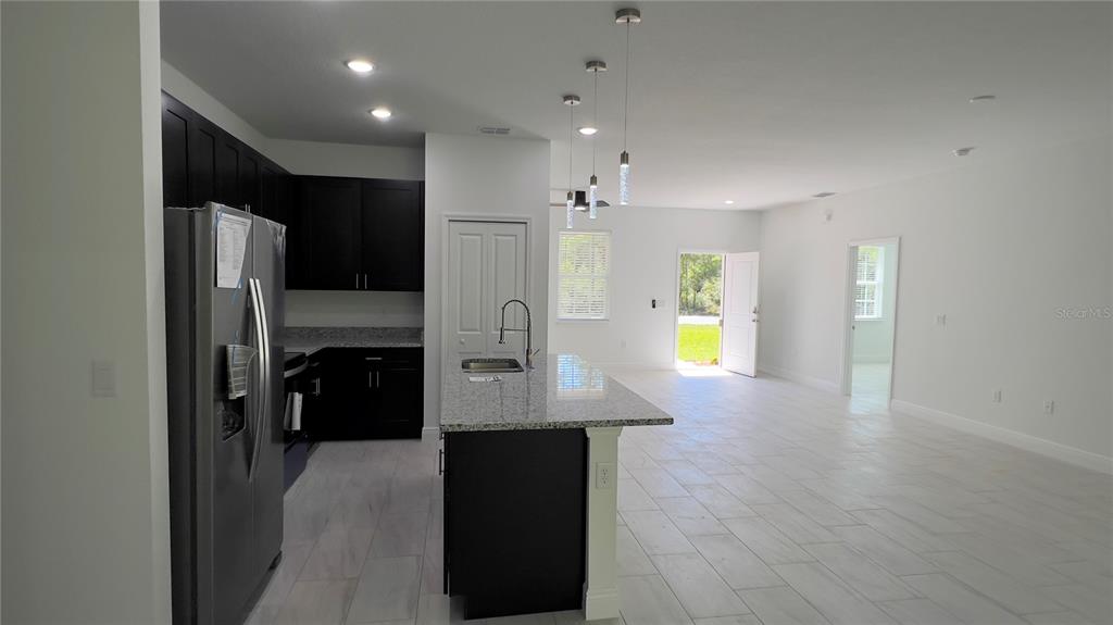 5027 Southwest 165th St Road Ocala, FL 34473 - Photo 13 of 33 a kitchen with stainless steel appliances a refrigerator and a stove top oven