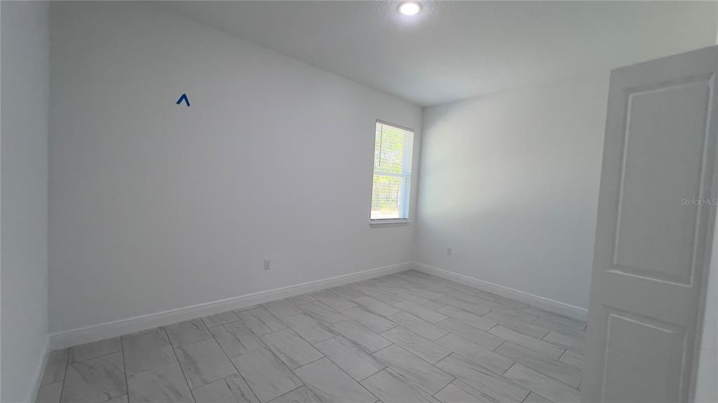 5027 Southwest 165th St Road Ocala, FL 34473 - Photo 17 of 33 an empty room with a window