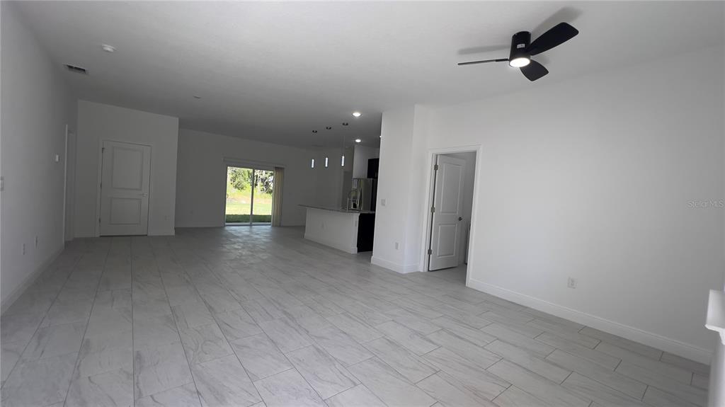 5027 Southwest 165th St Road Ocala, FL 34473 - Photo 2 of 33 wooden floor in an empty room with a window