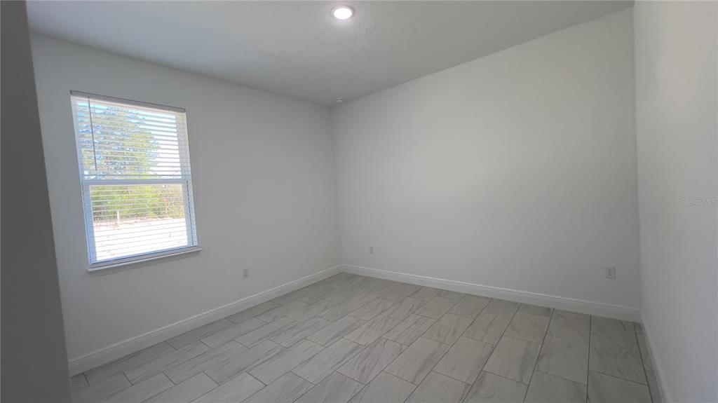 5027 Southwest 165th St Road Ocala, FL 34473 - Photo 22 of 33 an empty room with a window