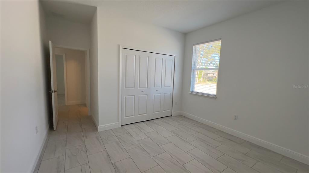 5027 Southwest 165th St Road Ocala, FL 34473 - Photo 23 of 33 an empty room with windows