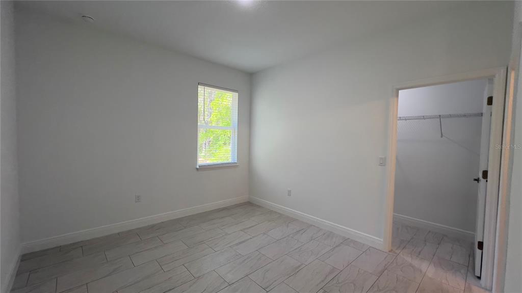 5027 Southwest 165th St Road Ocala, FL 34473 - Photo 24 of 33 a view of an empty room with a window