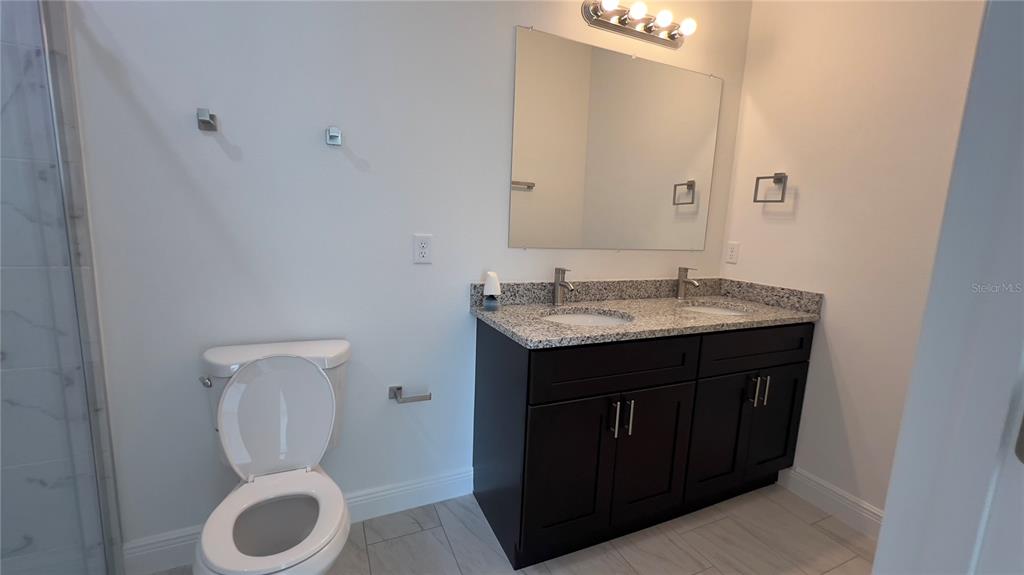 5027 Southwest 165th St Road Ocala, FL 34473 - Photo 30 of 33 a bathroom with a toilet sink and mirror