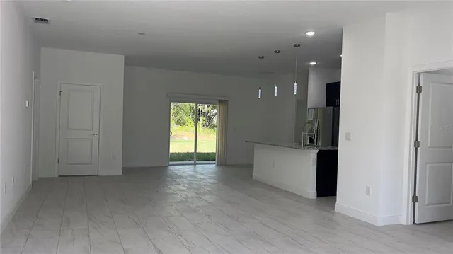 an empty room with windows and closet