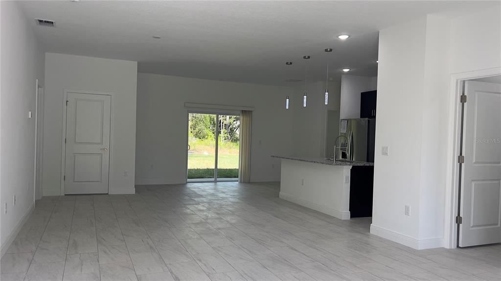 5027 Southwest 165th St Road Ocala, FL 34473 - Photo 3 of 33 an empty room with windows and closet