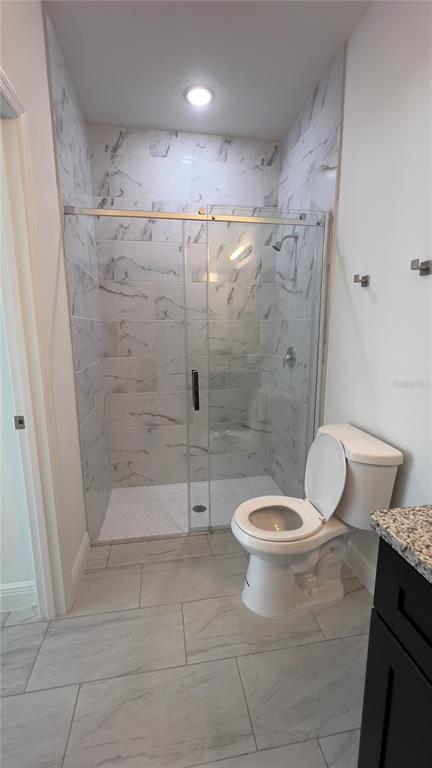 5027 Southwest 165th St Road Ocala, FL 34473 - Photo 31 of 33 a bathroom with a toilet and a shower