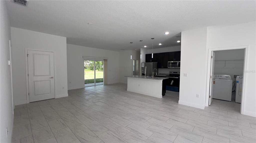 5027 Southwest 165th St Road Ocala, FL 34473 - Photo 5 of 33 a view of a kitchen with a sink and a refrigerator