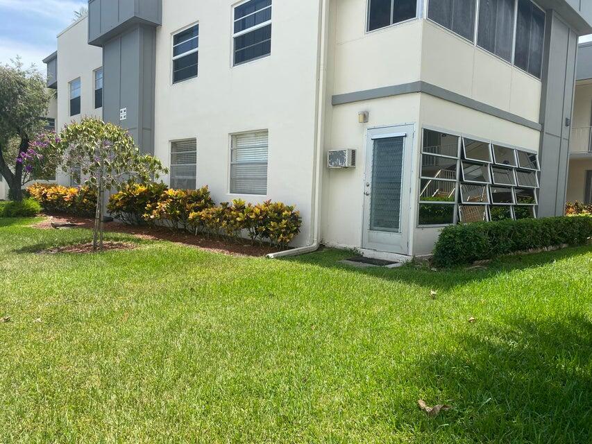 542 Normandy Lane Delray Beach, FL 33484 - Photo 19 of 32 a front view of a house with a garden