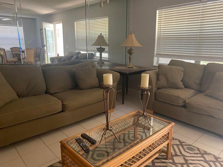 542 Normandy Lane Delray Beach, FL 33484 - Photo 2 of 32 a living room with furniture and a table