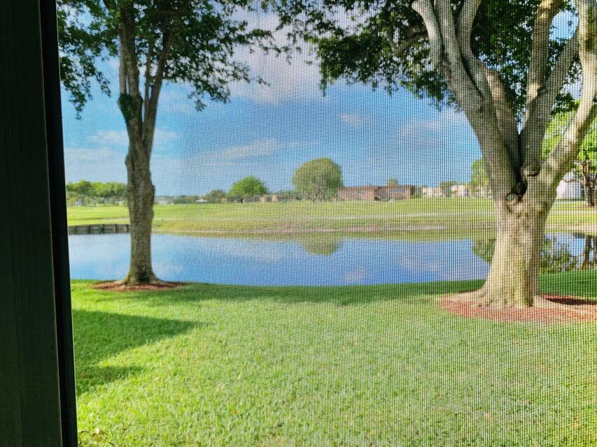 542 Normandy Lane Delray Beach, FL 33484 - Photo 23 of 32 a view of yard with swimming pool and trees