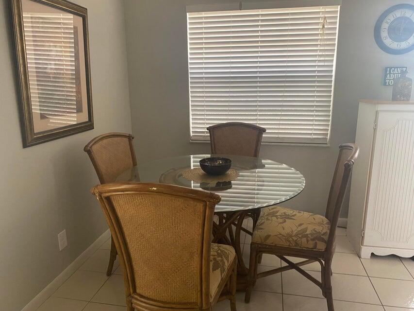 542 Normandy Lane Delray Beach, FL 33484 - Photo 6 of 32 a view of a room with a table and chairs
