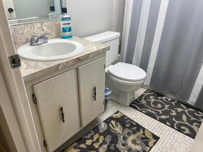 542 Normandy Lane Delray Beach, FL 33484 - Photo 10 of 32 a bathroom with a sink toilet and shower