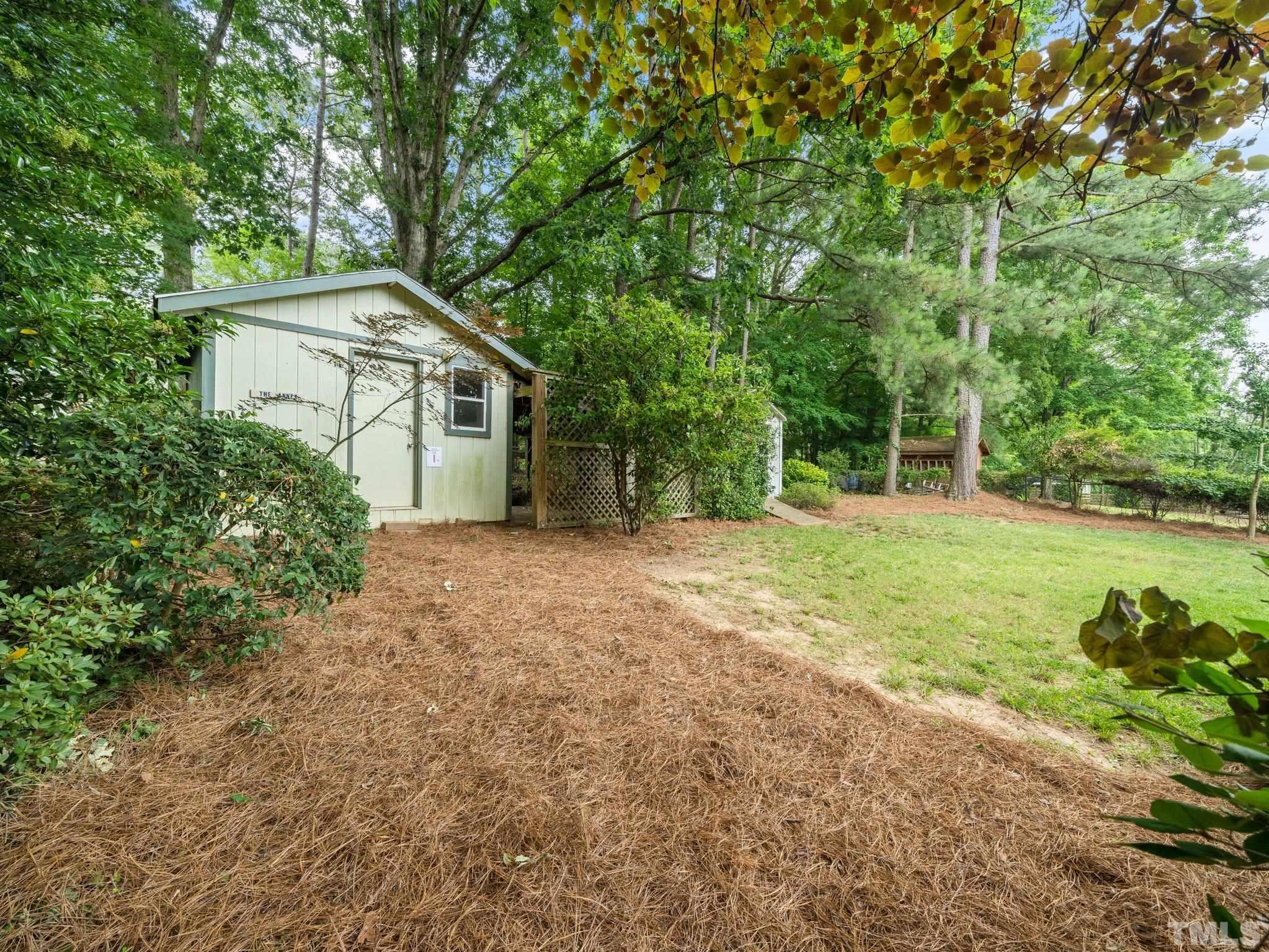 1413 Ashburton Road Raleigh, NC 27606 - Photo 20 of 27 a view of a house with backyard and garden