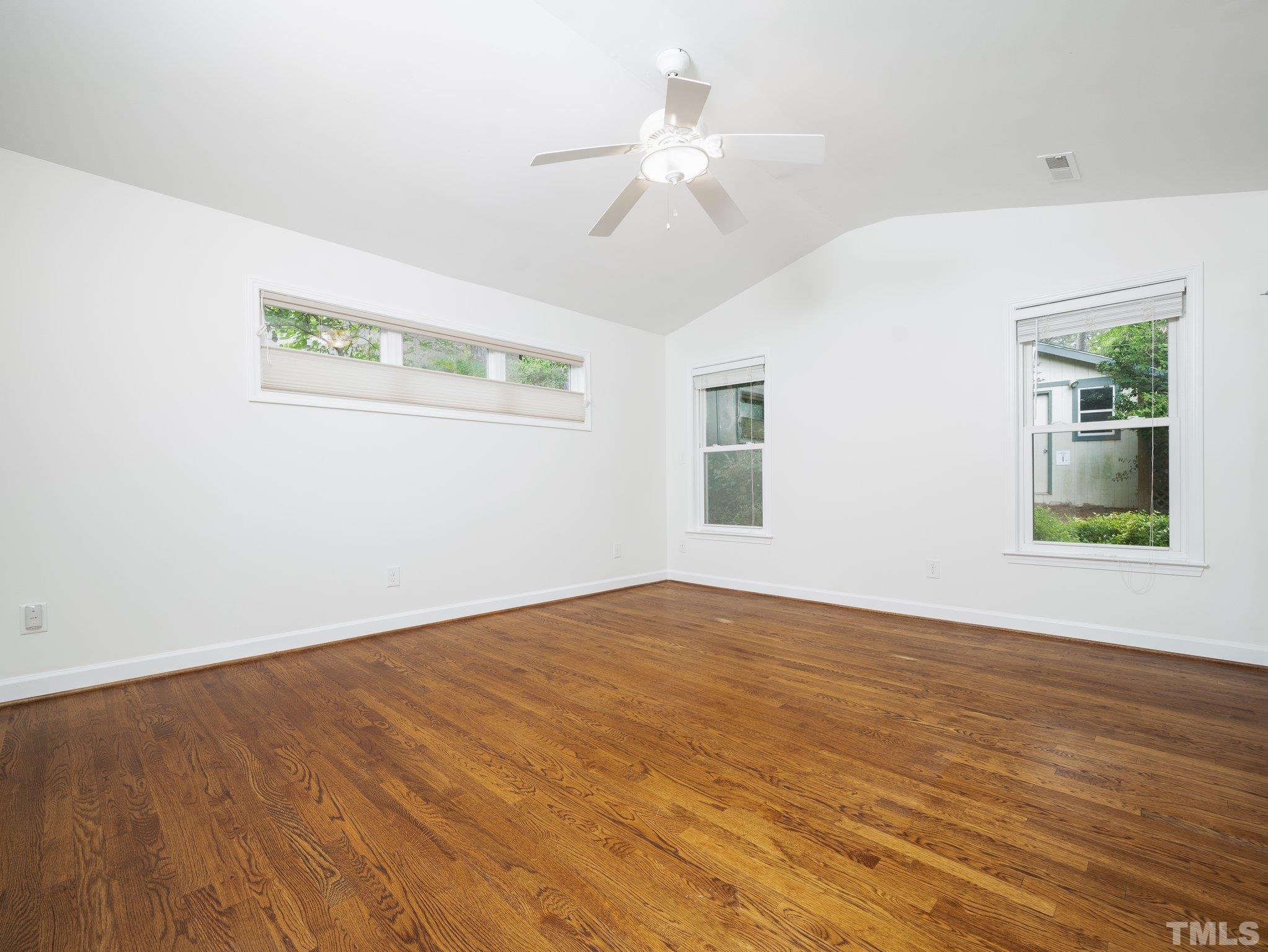1413 Ashburton Road Raleigh, NC 27606 - Photo 8 of 27 wooden floor in an empty room with a window