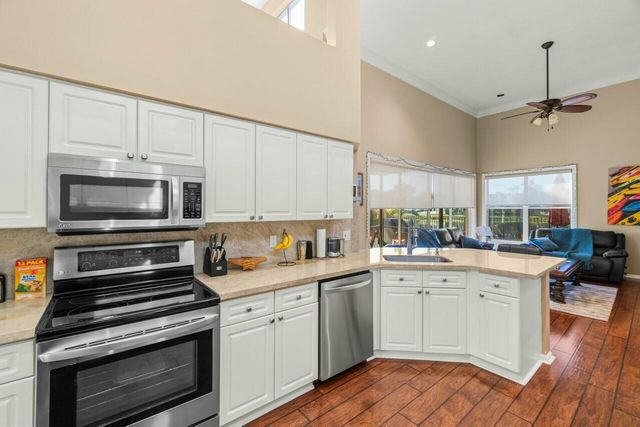 a bathroom with a granite countertop sink a toilet mirror and bathtub