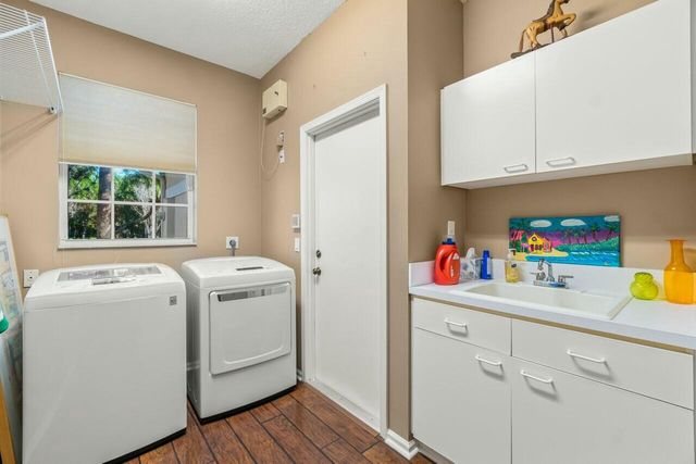 a spacious bathroom with a granite countertop sink a toilet and a mirror