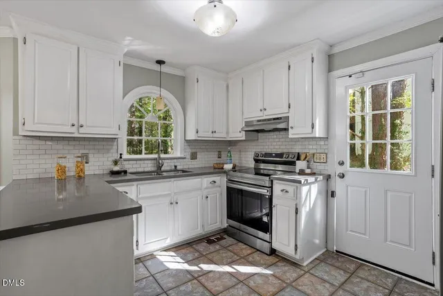 a kitchen with a sink stove and cabinets