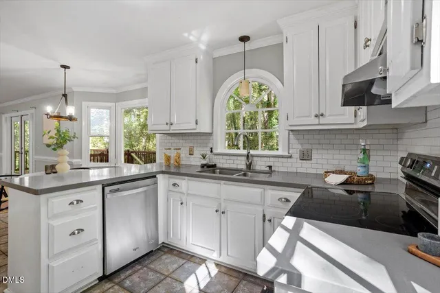 a kitchen with a sink stove and cabinets