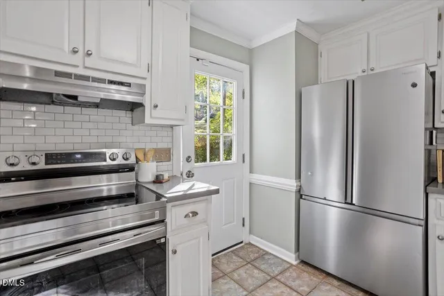a kitchen with stainless steel appliances a refrigerator sink and cabinets