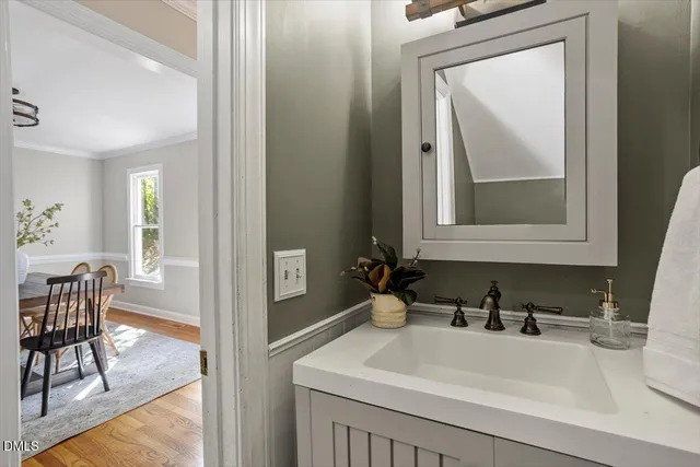 a bathroom with a sink and a mirror with a vanity