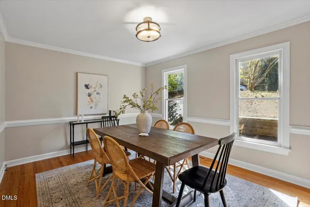 a view of a dining room with furniture and wooden floor