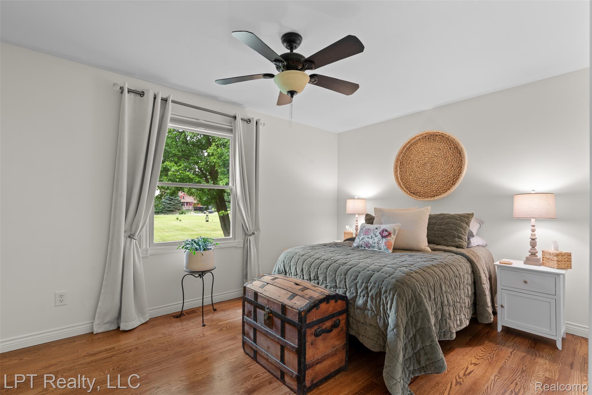 2588 East Jones Road Howell, MI 48855 - Photo 13 of 40 Bedroom with a ceiling fan and wood finished floors