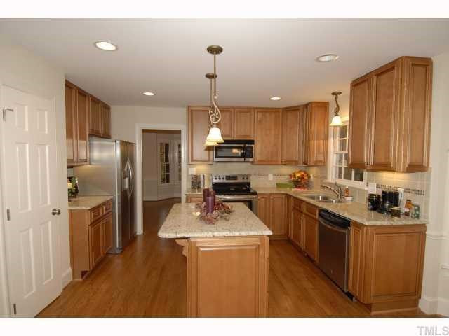 5229 Caber Road Raleigh, NC 27613 - Photo 3 of 12 Tile backsplash and upgraded lighting fixtures. Kitchen