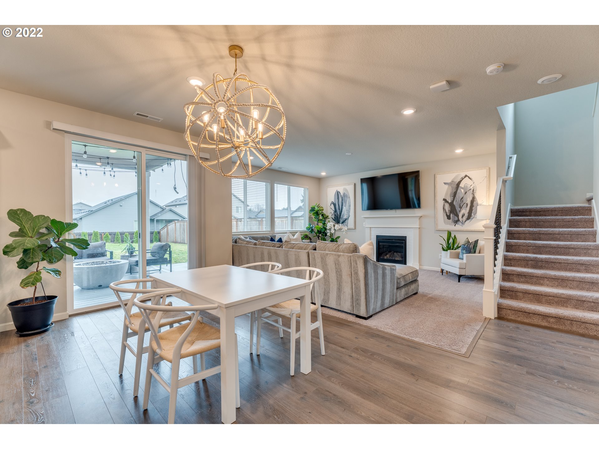 13305 Northeast 114th Way Brush Prairie, WA 98606 - Photo 10 of 31 a view of a dining room with furniture a chandelier and wooden floor