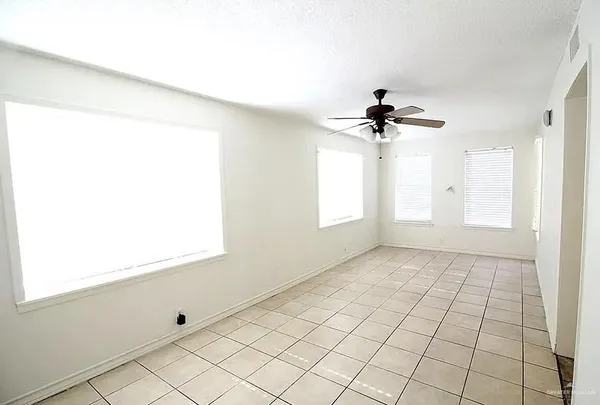 a view of an empty room and a window