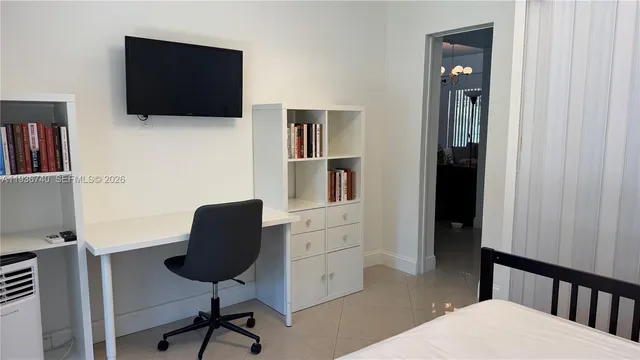 a view of a livingroom with furniture and a flat screen tv