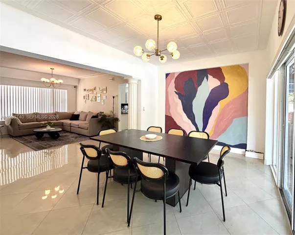 a view of a dining room with furniture and chandelier